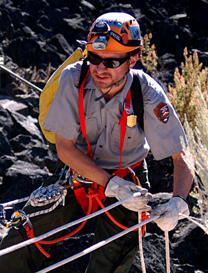 NPS ranger practicing cave rescue.